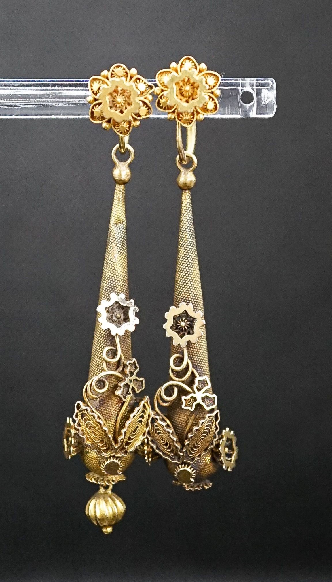 A pair of Victorian texture yellow metal pear shaped drop earrings, with star and foliate motifs(a.f.), 45mm, 5.8 grams.